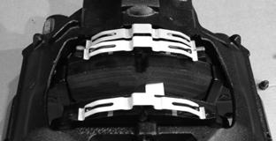 Manually push the brake caliper outboard until the inboard brake pad contacts the rotor (Figure 32). 7. Insert the brake pad on the outboard side.