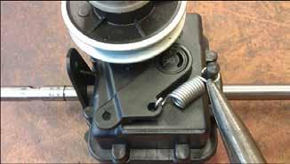 Unhook the tensioning spring, slacken off the set screws which clamp the gearbox mounting