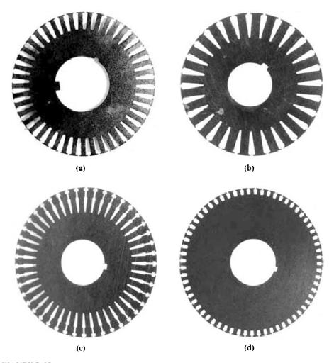 Laminations from typical cage induction motor rotors, showing the cross section of the rotor bars: (a) Class A: large bars near the