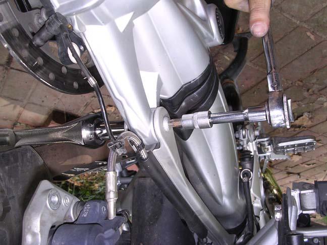 9. Reconnect the paralever link. (Install the bolt and nut and torque it down to 43 nm.