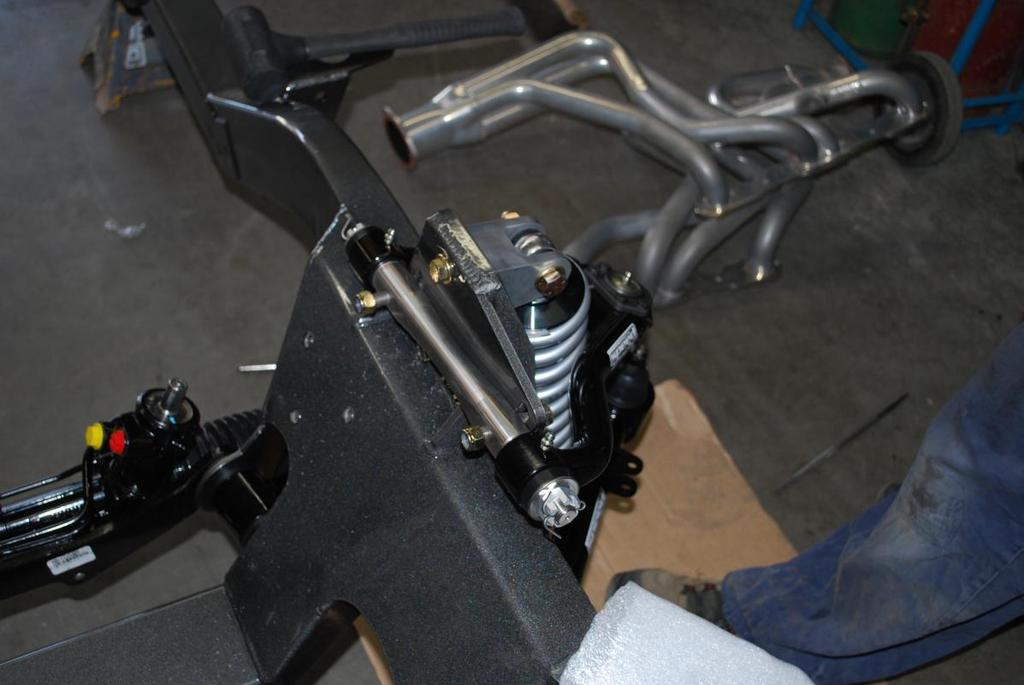 arm should be towards the rear. These holes in the frame are slotted to allow adjustment of the suspension's camber curve.