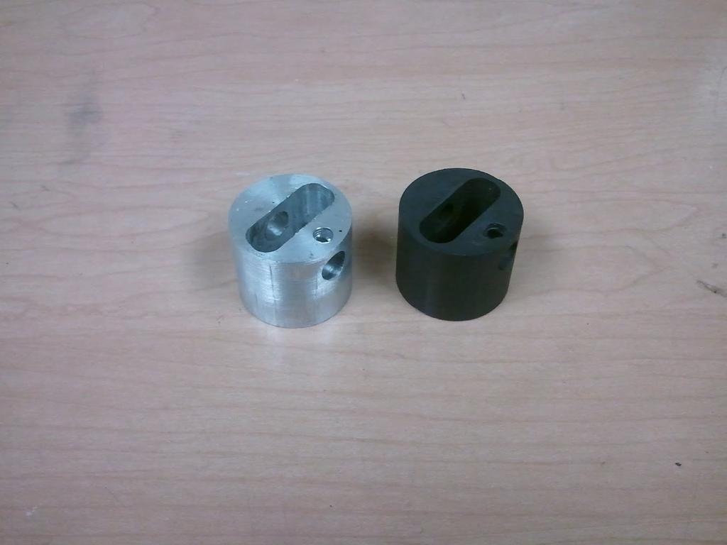 4 grams. Figure 18 - Aluminum piston and graphite piston (black) Two identical pistons were machined, one out of aluminum and the other graphite. The aluminum weighed 33.