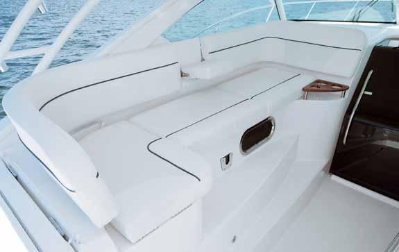 navigation center, curved companion lounge with removable Teak table, and starboard aft-facing mezzanine seat.