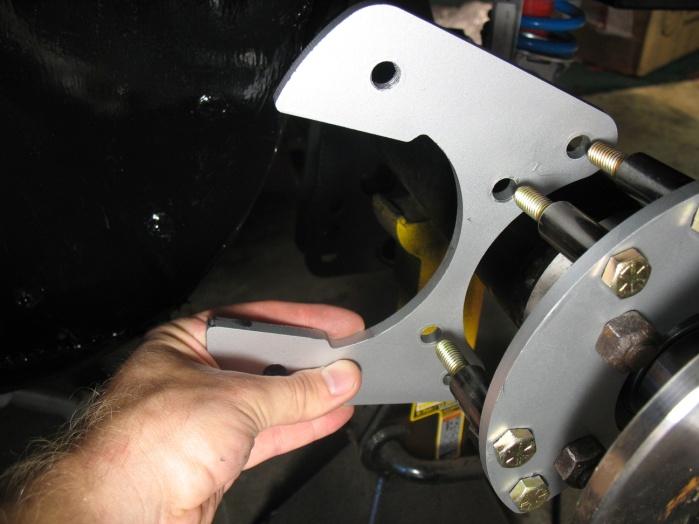 7. Install the caliper mounting brackets Take
