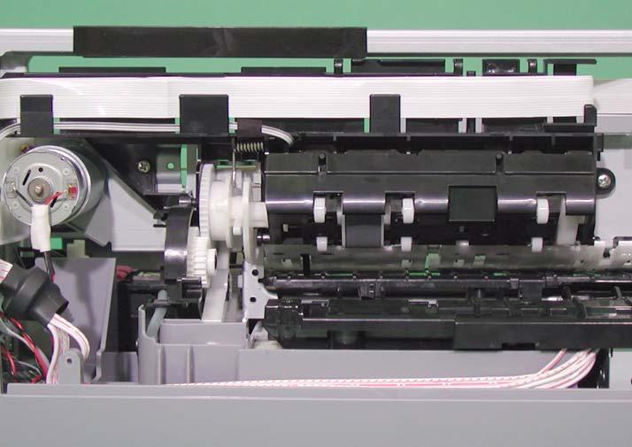 Looking at the printer from its back side, press down "Paper Guide, Upper" on the left, and release "PE Sensor Lever" from the slot.