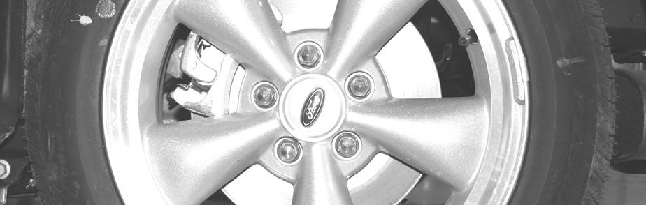 Verify all lug nuts and the wheels are firmly seated into place, and slowly lower the rear of the vehicle onto the ground.