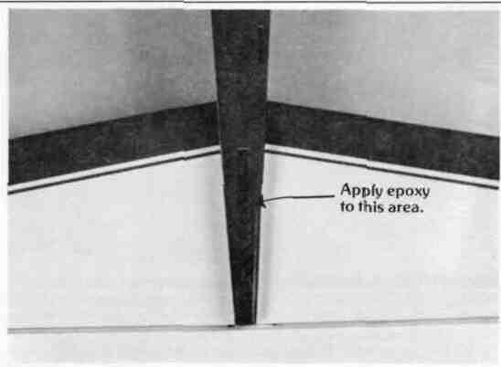 of epoxy and apply it to the area inside the fuselage on the surface of the exposed wood Apply an even coat to the vertical stabilizer base where you removed the