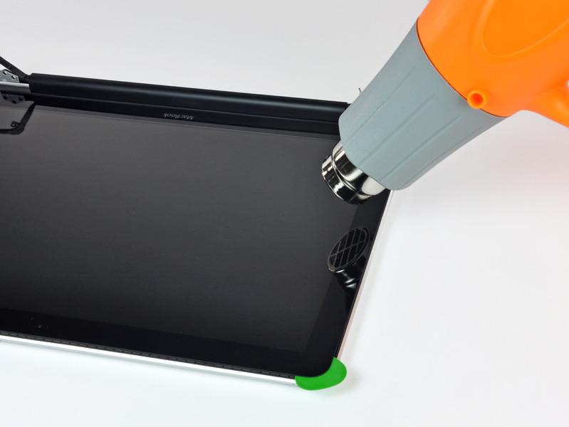 Step 21 Use a heat gun to soften the adhesive under the black strip along the left side of the front glass panel.