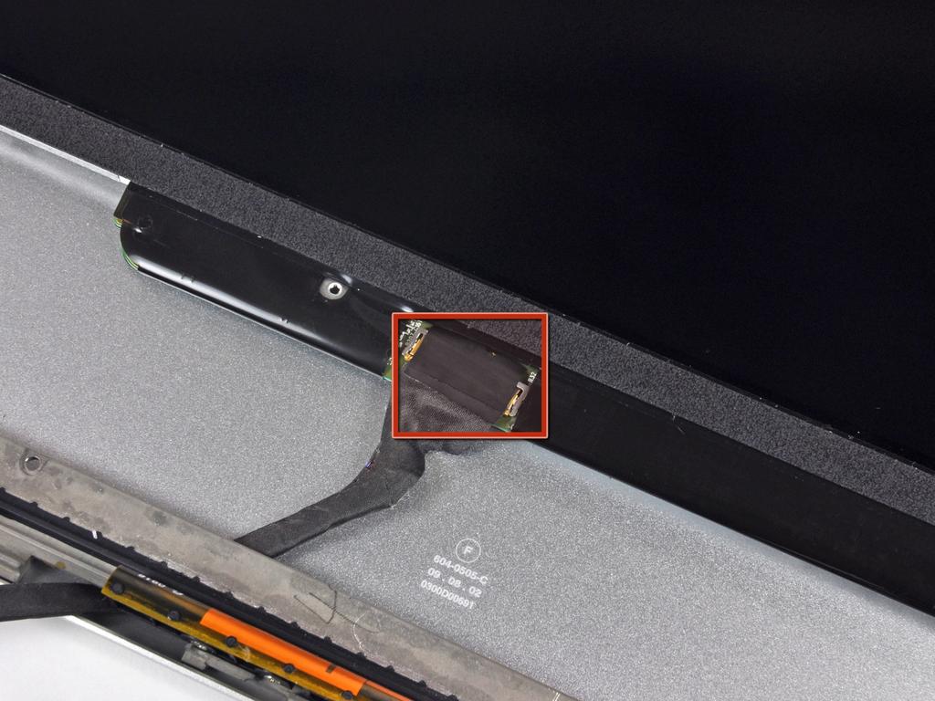 It may be helpful to use one hand to feed the display data cable through its channel in the aluminum display assembly as you