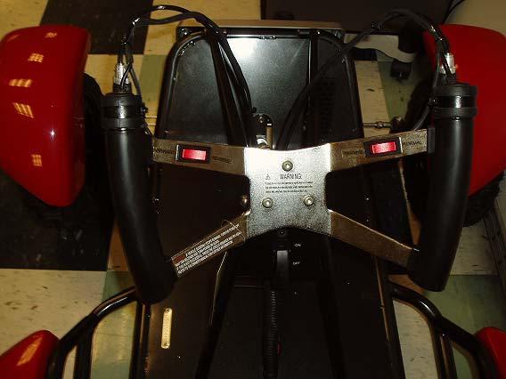 Figure 74: As received steering wheel on go-kart. The two hand pedals located behind the wheel on the right and left sides will be modified for braking and acceleration, respectively.