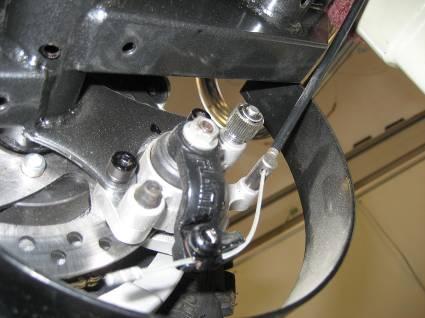 2.3.2.5 Disc Brakes The E-Racer has disc brakes, which work by depressing brake pads around a rotor when the brake wires are pulled. The disc brakes on the E-Racer are shown in Fig. 98 below. 2.3.3 Joystick Attachment Figure 98: Disc brakes on the E-Racer.