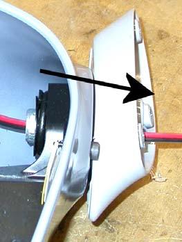 Carefully place one of the drive pins back into the upper socket on the motor actuator. Align the nub of the drive pin so it points to the round plug in the center of the mirror mount.