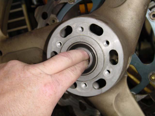 8. While you ve got the wheels out, wedge your fingers into the bearing inner races, press in, and rotate the inner race. It should be nice and smooth.