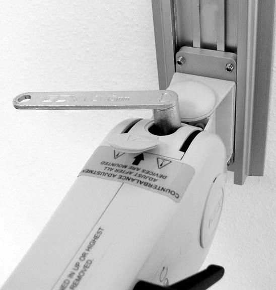 Lock Arm in horizontal position. 2. Open the Adjuster Cover by inserting a flat blade screwdriver in the slot at the rear of the Cover and prying upward.