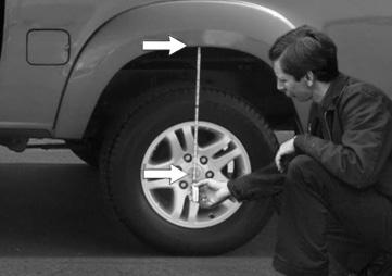 Measure the distance between the center of the hub and the bottom edge of the wheel well (fig. B.