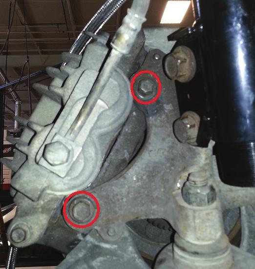 5. Reinstall the brake rotor and brake caliper (fig. 23). Torque the brake caliper bolts to 88 Nm (65 ft-lbs.). fig. 23 6.