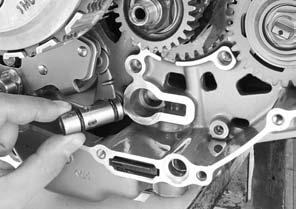 Apply engine oil to the oil pump driven gear teeth. Install the oil pump driven gear while aligning the flats of the oil pump driven gear and oil pump shaft.