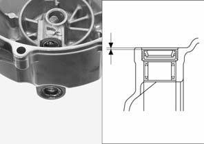 clutch lifter arm needle bearings until the specified depth, using the special tools as shown.