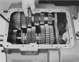 position with the reverse gear held against LO speed gear and rear of shaft moved into case