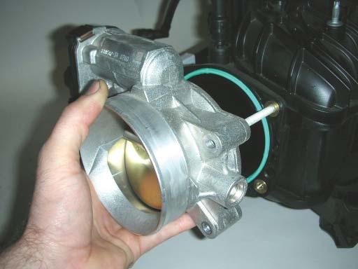 Using a 10mm socket wrench, remove the stock throttle body