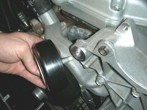 73. Using a 15mm socket wrench, remove the factory idler pulley.