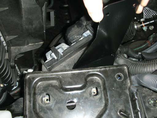 Lift up on the secondary battery tray and slide the intercooler