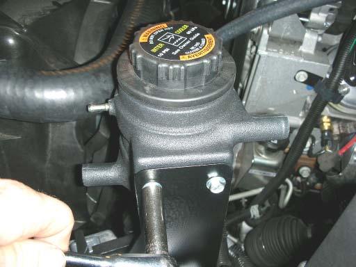 128. Mount the intercooler reservoir tank to the bracket using the