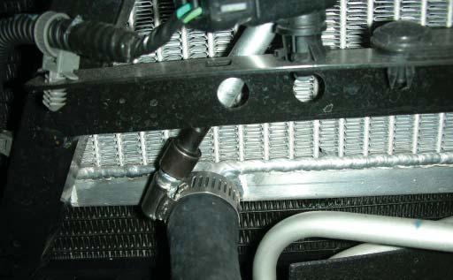 Trim the hose to fi t, connect it to the intercooler reservoir tank upper ¾ hose barb, and tighten with the