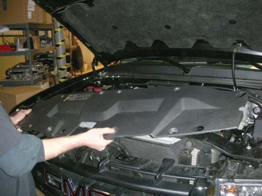 Reinstall the radiator support cover on the vehicle using the stock hardware (refer