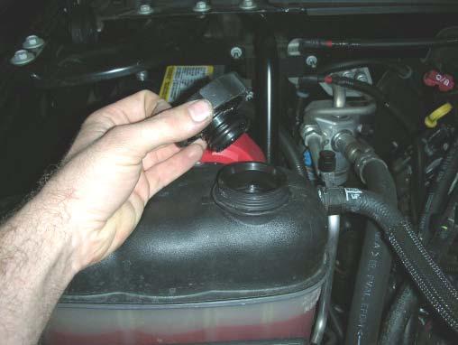 13. Disconnect the loom clamp from the upper radiator hose using a small fl at blade screwdriver. 14.