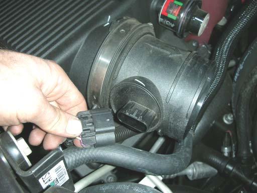 17. Place a drain pan under the front of the truck and disconnect the heater hose on