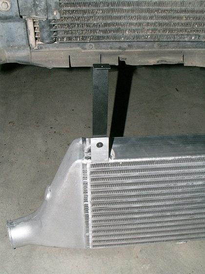 14) Install the two upper intercooler support brackets onto the aluminum