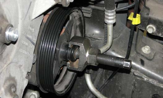61. Use a pulley removal tool to remove the power steering pump pulley. 66. Remove the oil filter and allow engine oil to drain.