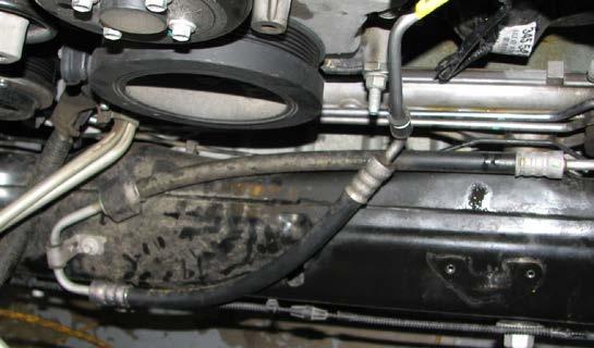 Position a drain pan below the radiator then disconnect the lower radiator hose from the engine. 64.