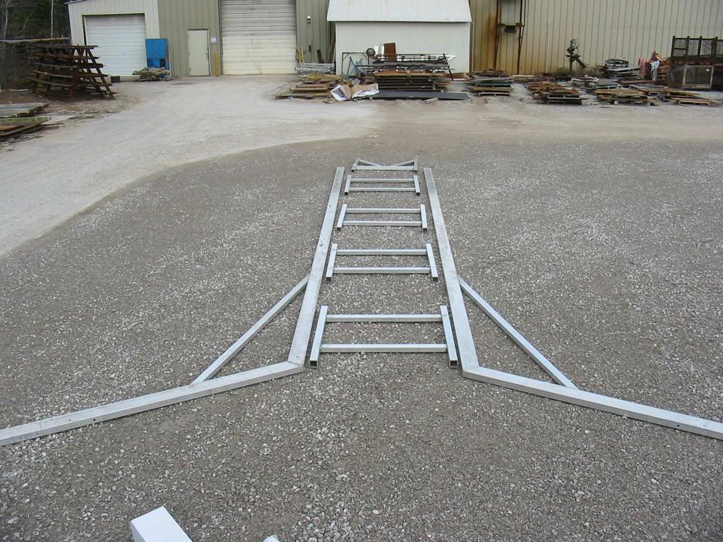 Once you have don this find a level spot to put the hoist together. Lay the 2 side panels on the ground as shown.