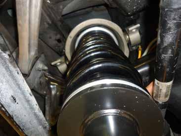 INSTALL THE NEW REAR COIL SPRING STRUT IN THE TOP MOUNT AND SECURE THE