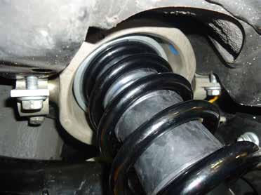 INSTALL THE COIL SPRING STRUT INTO THE REAR SHOCK CAVITY.