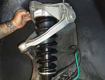 INSTALL THE NEW FRONT COIL SPRING STRUT INTO THE TOP MOUNT AND SECURE