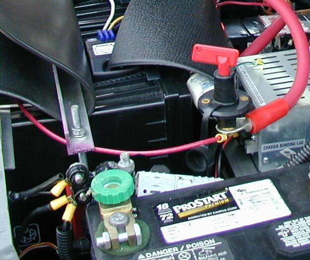 Below you can see the red flag keyed Lock Out Switch. When Key is removed, the positive terminal is open. No connection to the circuit breaker on the table top.
