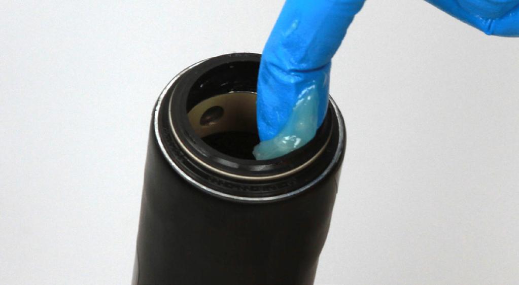 8 Use your fingers to remove the wire spring from a new dust wiper seal. Position the new dust wiper seal onto the flangeless dust wiper seal installation tool.