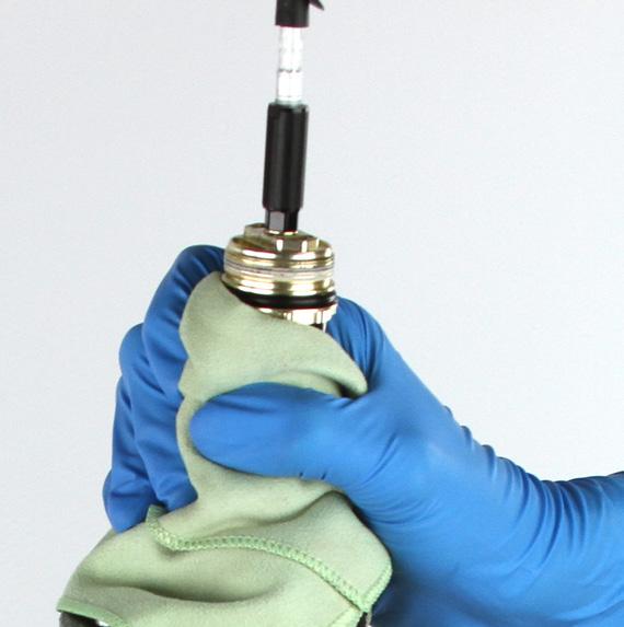 13 Wrap a rag around the bleed hole and firmly grasp the cartridge tube to prevent fluid from ejecting from the bleed hole.
