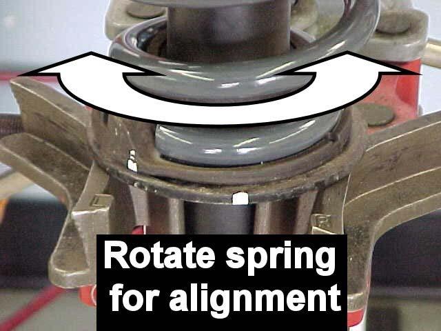 13) Once aligned, compress the coil spring and install the shaft nut back on.
