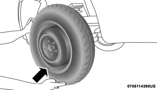 7. Mount the spare tire. CAUTION! Be sure to mount the spare tire with the valve stem facing outward. The vehicle could be damaged if the spare tire is mounted incorrectly.