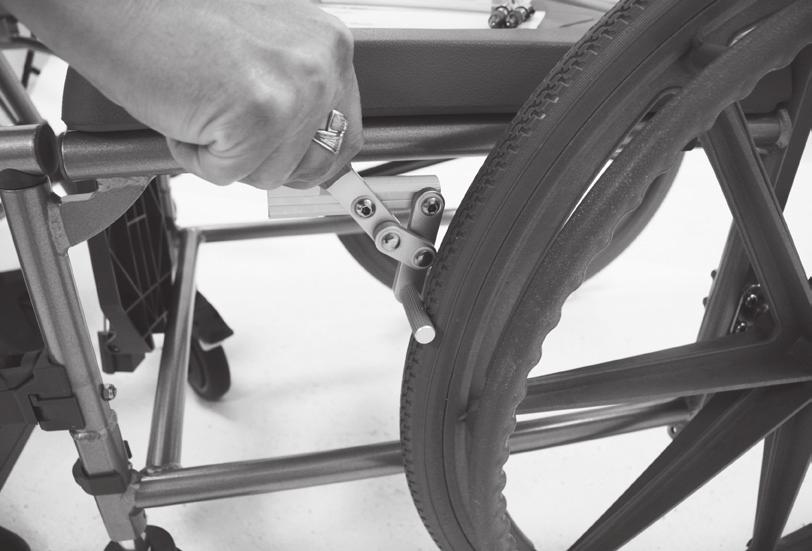 12a) LOCK RELEASE 24 Wheel Operation When the 24 rear wheels are installed, the chair can be propelled by either the attendant or the chair