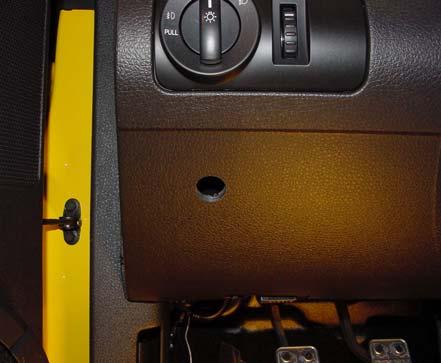 6. Drill a ¾ inch hole through the lower dash kick panel, inner and outer panels. Center of hole should be located 1¾ inch down from trim line and 2½ inch over from left corner of dash kick panel.