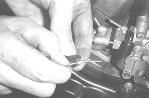 Remove the jet needle by removing the needle clip. Check the jet needle and throttle valve for wear or damage.