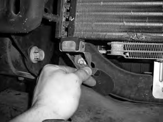 11. The A/C condenser brackets will need to be removed to gain access to the bolt. Figure 4 Remove the brackets from the core support and save along with the mounting bolts. Figure 4 12.