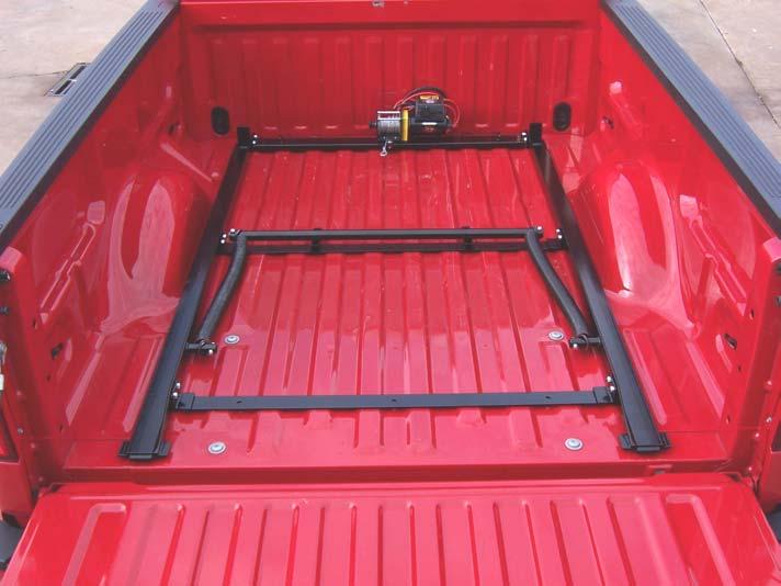 1. Insert the Cruiser Ramp into the bed at this time as shown below. Be careful not to scratch the bed. 2. Center the frame from side to side in the pick-up bed. 3.
