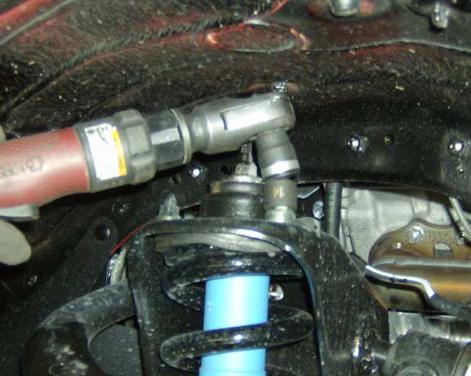 Remove the upper control arm nut and bolt so that the control arm can be removed completely.