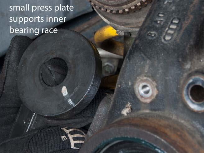 NOTE: The flat face of the small plate should press only against the inner race of the inner bearing.